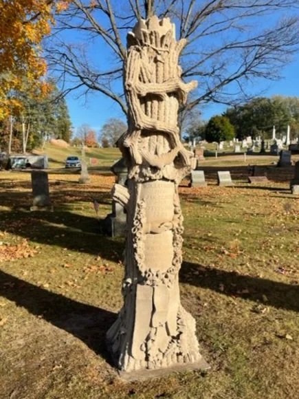 The Rathbun tree monument after cleaning, with its carved bark and branches visible