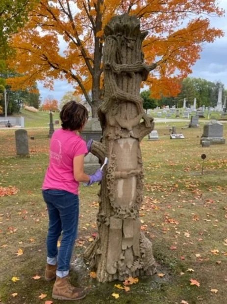 Hand scrubbing the Rathbun tree monument during restoration